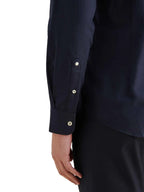 Navy blue shirt with button details on a white background